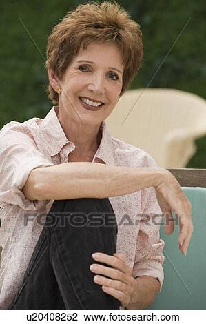 Stock Image - Portrait of senior woman sitting outdoors. Fotosearch