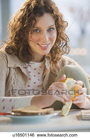 Portrait of woman peeling orange View Large Photo Image Stock Photograph - Portrait of woman peeling orange. Fotosearch