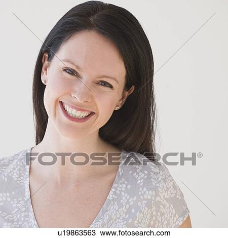 Stock Image - Portrait of woman smiling. Fotosearch
