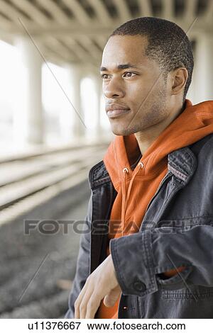 Stock Photo - Portrait of young man looking pensive. Fotosearch