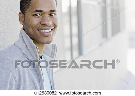 Stock Image - Portrait of young man smiling. Fotosearch