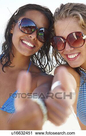 Portrait of young women posing on beach View Large Photo Image Stock Image - Portrait of young women posing on beach. Fotosearch