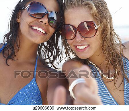 Portrait of young women posing on beach View Large Photo Image Stock Photo - Portrait of young women posing on beach. Fotosearch