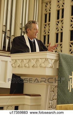 Priest standing at pulpit View Large Photo Image Stock Image - Priest standing at pulpit. Fotosearch