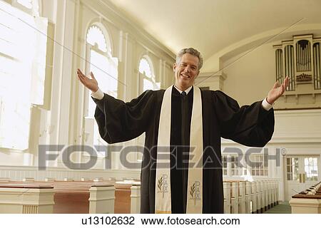 Priest with arms raised in church View Large Photo Image Stock Image - Priest with arms raised in church. Fotosearch