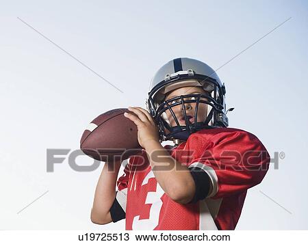 Stock Image - Quarterback preparing to throw football. Fotosearch