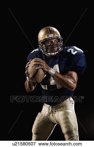 Stock Photo - Quarterback preparing to throw football. Fotosearch