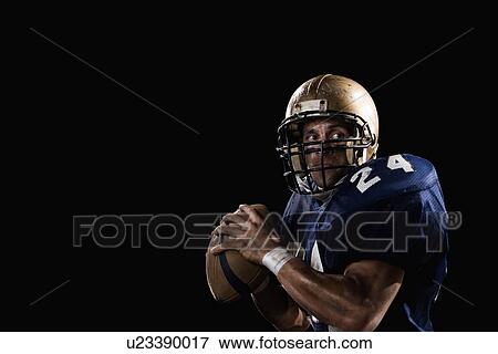 Stock Photo - Quarterback preparing to throw football. Fotosearch