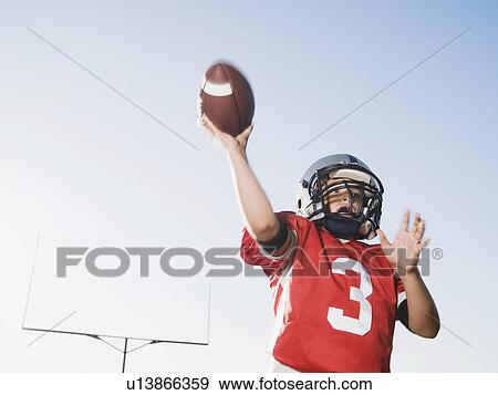 Stock Photo - Quarterback throwing football. Fotosearch