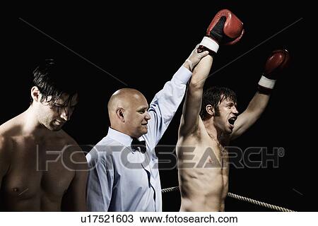 Referee standing between winning and losing boxers View Large Photo Image Stock Image - Referee standing between winning and losing boxers. Fotosearch