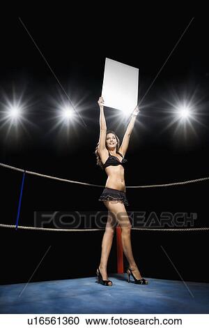 Ring girl holding sign in boxing ring View Large Photo Image Stock Image - Ring girl holding sign in boxing ring. Fotosearch