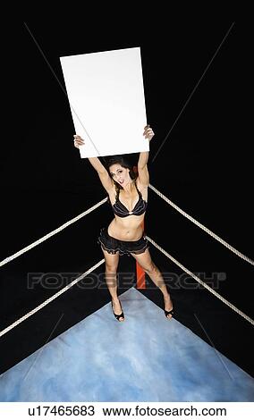 Ring girl holding sign in corner of boxing ring View Large Photo Image Stock Image - Ring girl holding sign in corner of boxing ring. Fotosearch