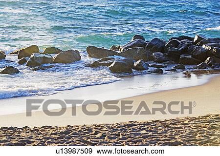 Rocks in water along beach View Large Photo Image Stock Photo - Rocks in water along beach. Fotosearch