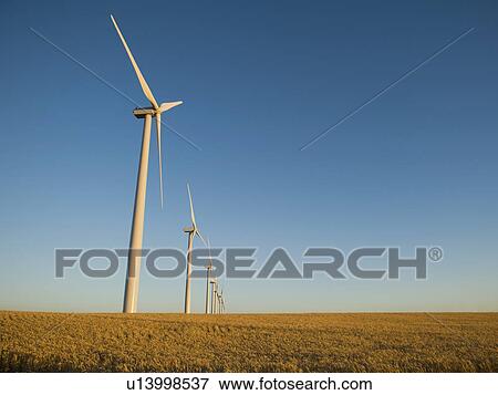 Row of windmills on wind farm View Large Photo Image Stock Photo - Row of windmills on wind farm. Fotosearch