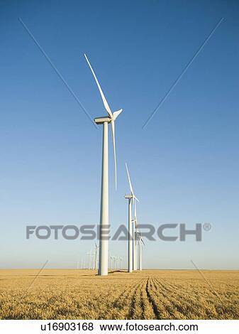 Stock Photo - Row of windmills on wind farm. Fotosearch