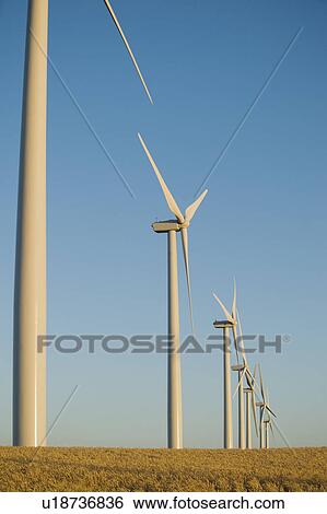 Stock Photograph - Row of windmills on wind farm. Fotosearch