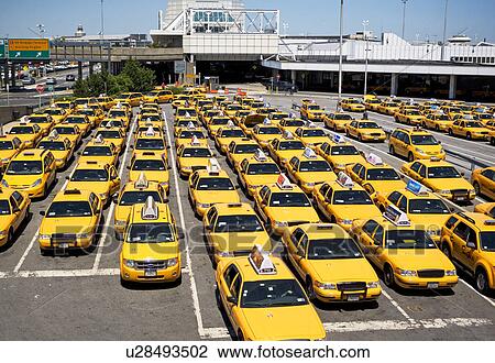 Stock Image - Rows of taxis waiting at airport. Fotosearch