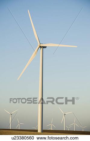 Stock Image - Rows of windmills on wind farm. Fotosearch