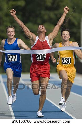 Runner breaking through finish line View Large Photo Image Stock Image - Runner breaking through finish line. Fotosearch