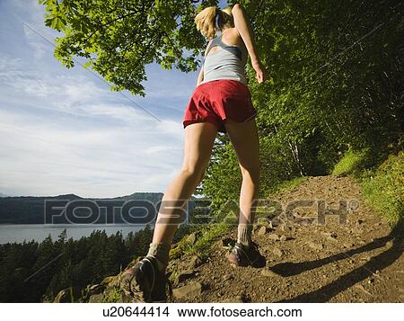 Picture - Runner on rocky trail. Fotosearch