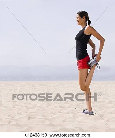Runner stretching on beach View Large Photo Image Stock Image - Runner stretching on beach. Fotosearch