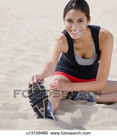 Runner stretching on beach View Large Photo Image Stock Photograph - Runner stretching on beach. Fotosearch