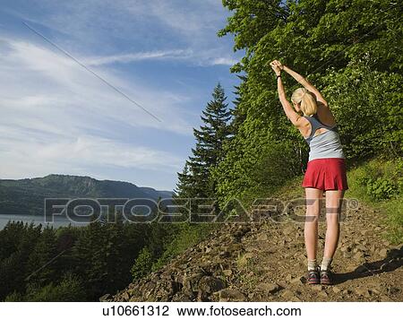 Runner stretching on rocky trail View Large Photo Image Stock Image - Runner stretching on rocky trail. Fotosearch