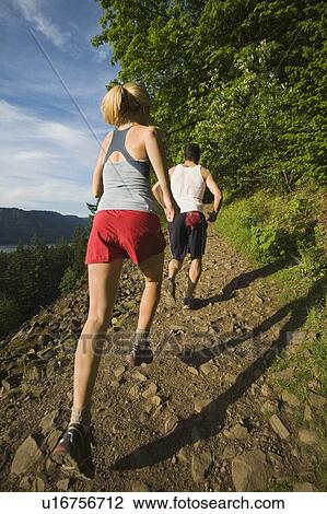 Stock Image - Runners ascending rocky trail. Fotosearch