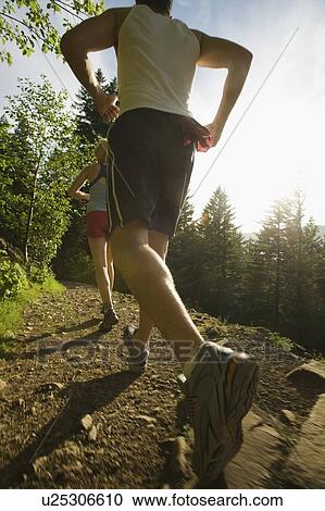 Runners ascending rocky trail View Large Photo Image Stock Image - Runners ascending rocky trail. Fotosearch