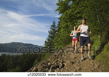 Runners descending rocky trail View Large Photo Image Stock Image - Runners descending rocky trail. Fotosearch