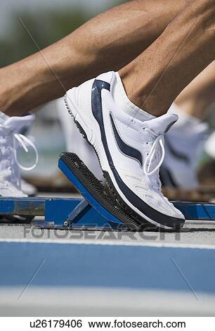 Stock Photograph - Runners on starter block. Fotosearch