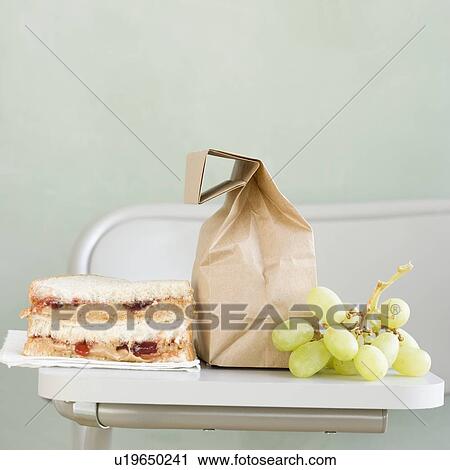 Sandwich and grapes next to paper bag View Large Photo Image Stock Image - Sandwich and grapes next to paper bag. Fotosearch