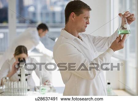 Scientist examining liquid in pharmaceutical laboratory View Large Photo Image Stock Image - Scientist examining liquid in pharmaceutical laboratory. Fotosearch