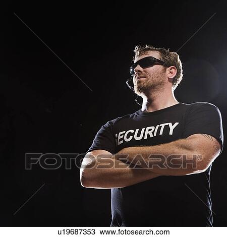 Security guard standing with arms crossed View Large Photo Image Stock Image - Security guard standing with arms crossed. Fotosearch