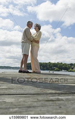Senior couple hugging on dock View Large Photo Image Stock Image - Senior couple hugging on dock. Fotosearch