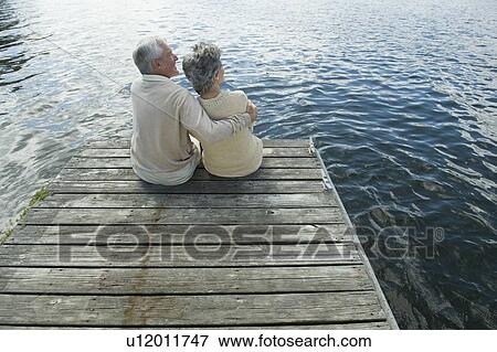 Senior couple hugging on dock View Large Photo Image Stock Photo - Senior couple hugging on dock. Fotosearch