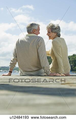 Senior couple sitting on dock View Large Photo Image Stock Image - Senior couple sitting on dock. Fotosearch