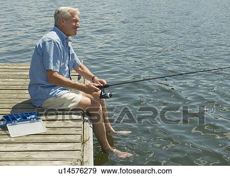 Senior man fishing off dock View Large Photo Image Stock Photo - Senior man fishing off dock. Fotosearch