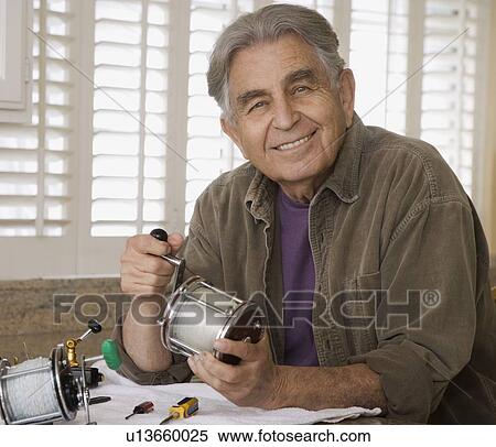 Senior man holding fishing reel View Large Photo Image Stock Photography - Senior man holding fishing reel. Fotosearch