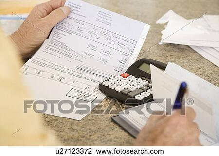 Senior man paying bills View Large Photo Image Stock Image - Senior man paying bills. Fotosearch