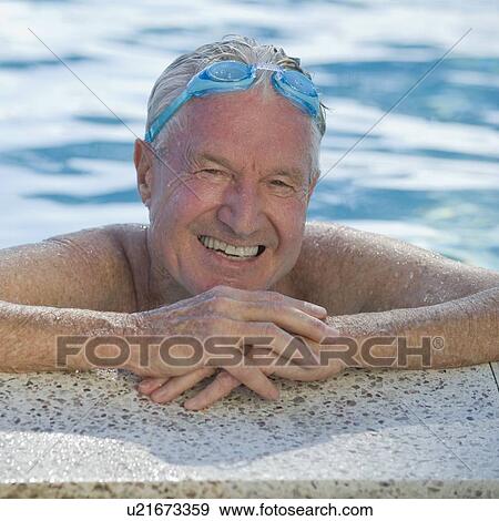 Stock Photo - Senior man resting on edge of swimming pool. Fotosearch