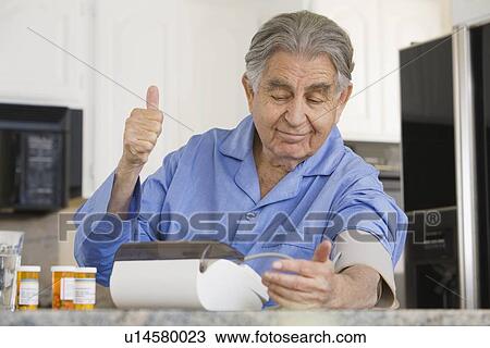Senior man taking own blood pressure View Large Photo Image Stock Image - Senior man taking own blood pressure. Fotosearch