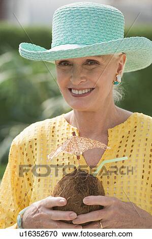 Senior woman holding tropical drink View Large Photo Image Stock Image - Senior woman holding tropical drink. Fotosearch