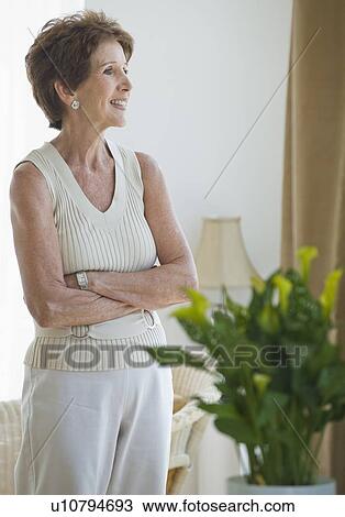 Senior woman looking out window View Large Photo Image Stock Image - Senior woman looking out window. Fotosearch