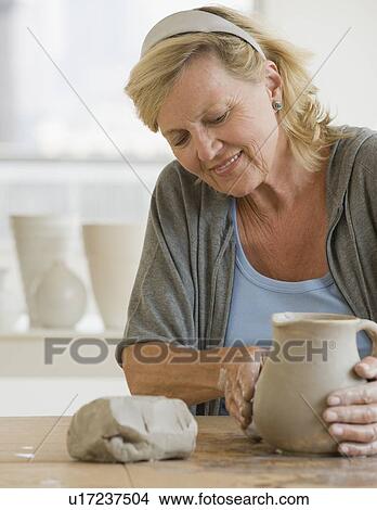 Picture - Senior woman making ceramic pot. Fotosearch