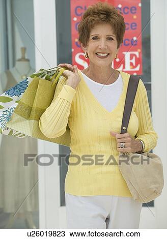 Stock Image - Senior woman shopping. Fotosearch