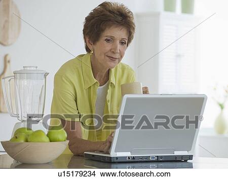 Picture - Senior woman using laptop. Fotosearch