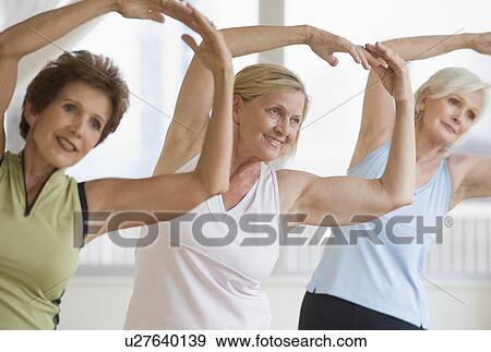 Stock Photo - Senior women doing yoga. Fotosearch