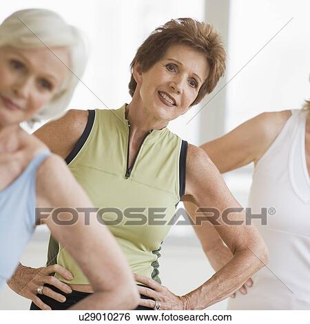 Stock Photograph - Senior women doing yoga. Fotosearch