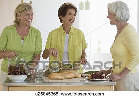 Stock Photography - Senior women preparing food. Fotosearch